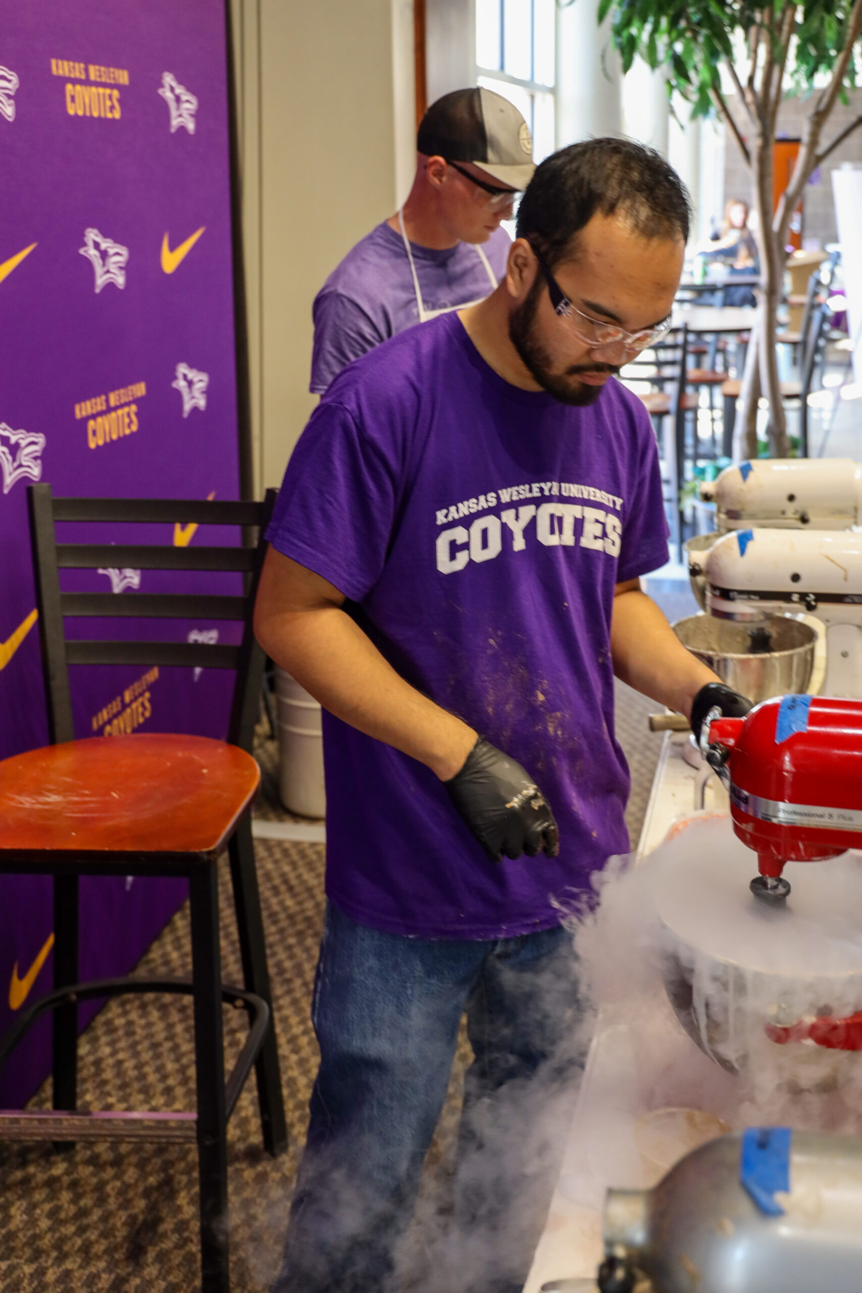 Man in t-shirt working with steaming liquid nitrogen