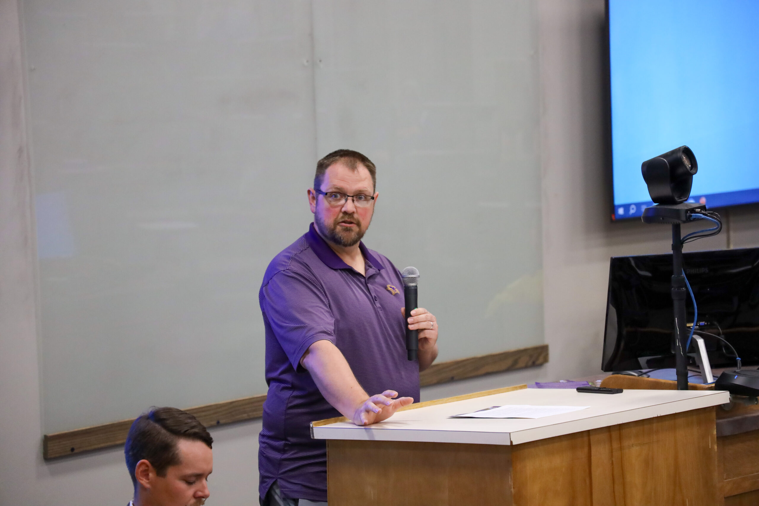 Man speaking in front of classroom