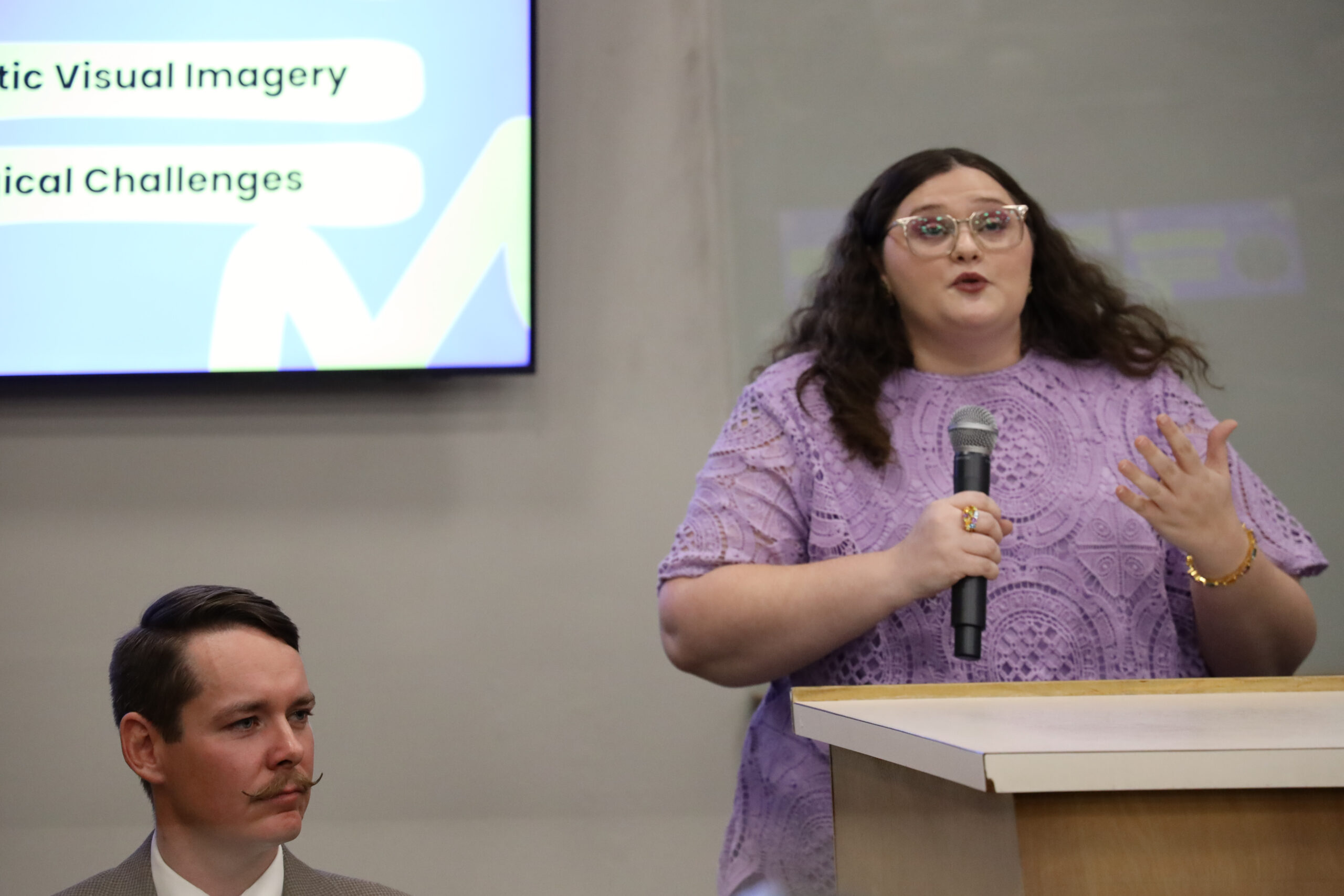 Woman speaking in front of classroom