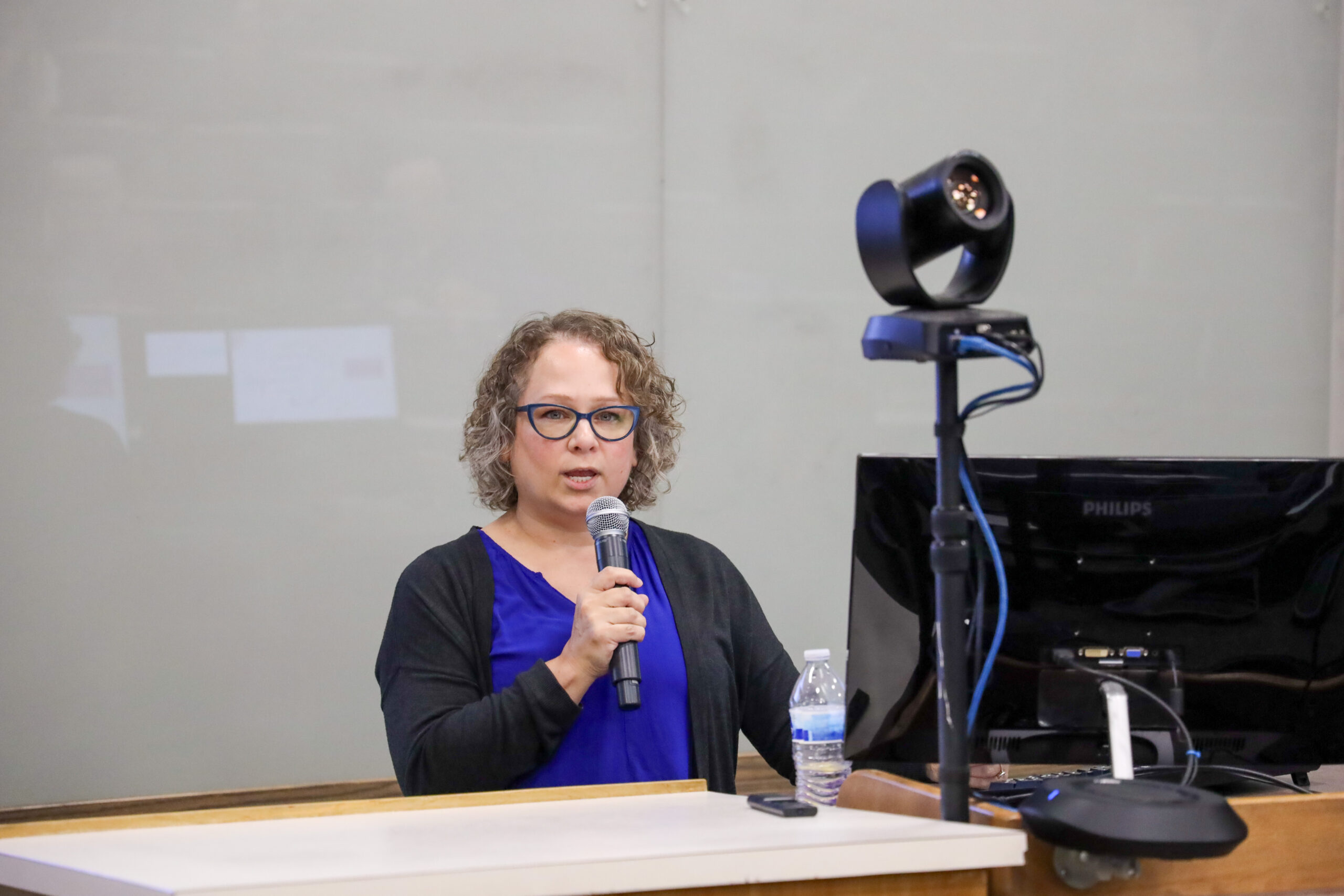 Woman speaking in front of classroom