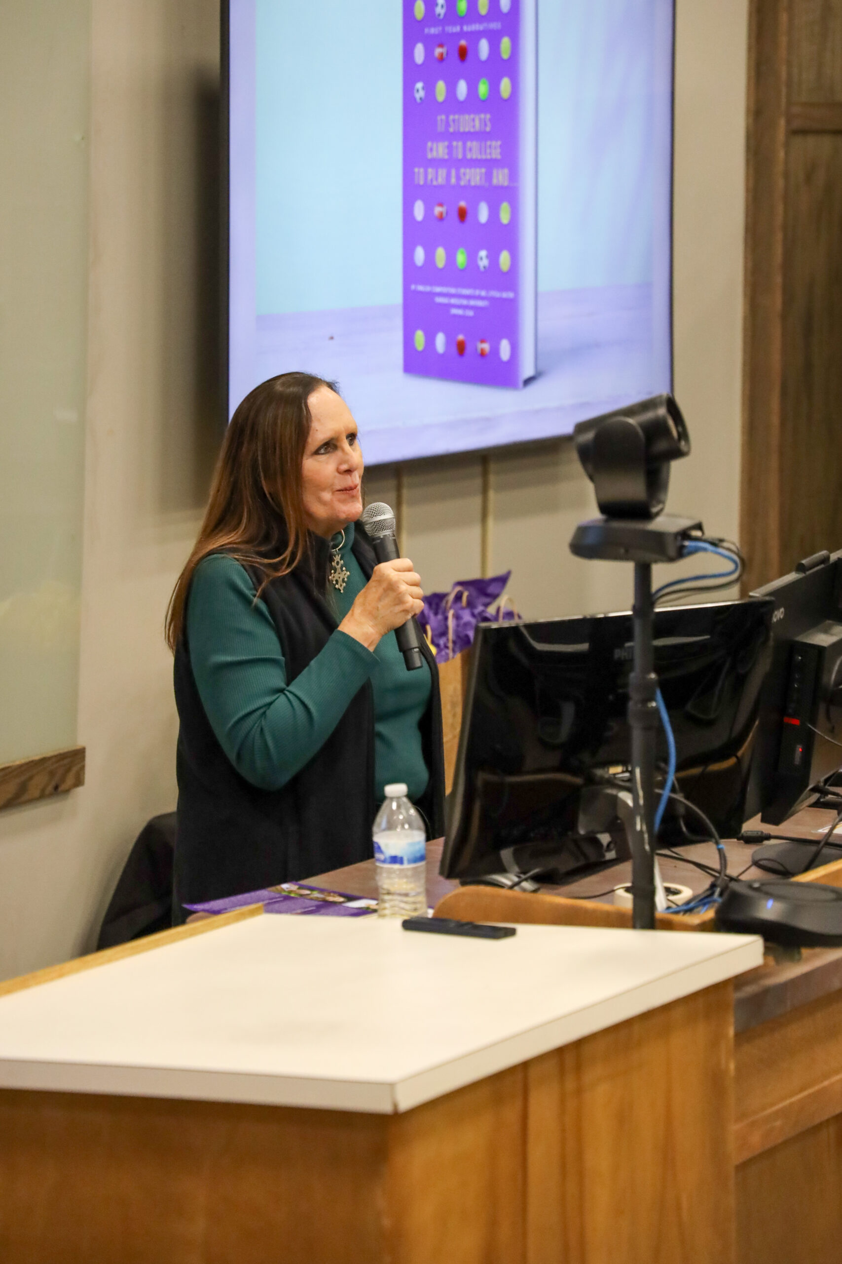 Woman speaking in front of classroom