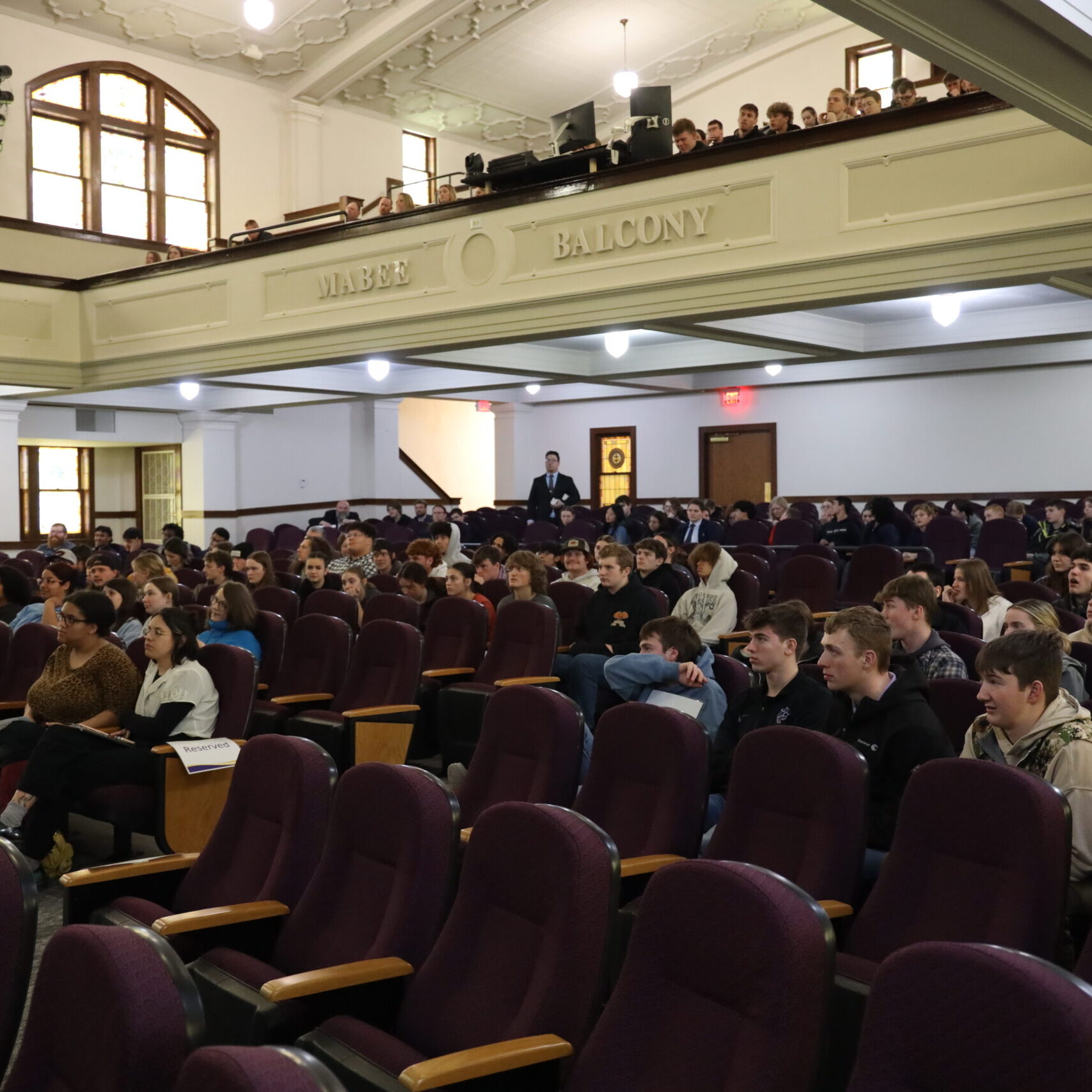 Crowd of people in seats in auditorium