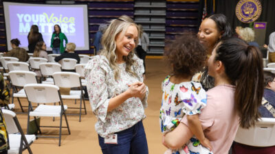 Women speaking in auditorium