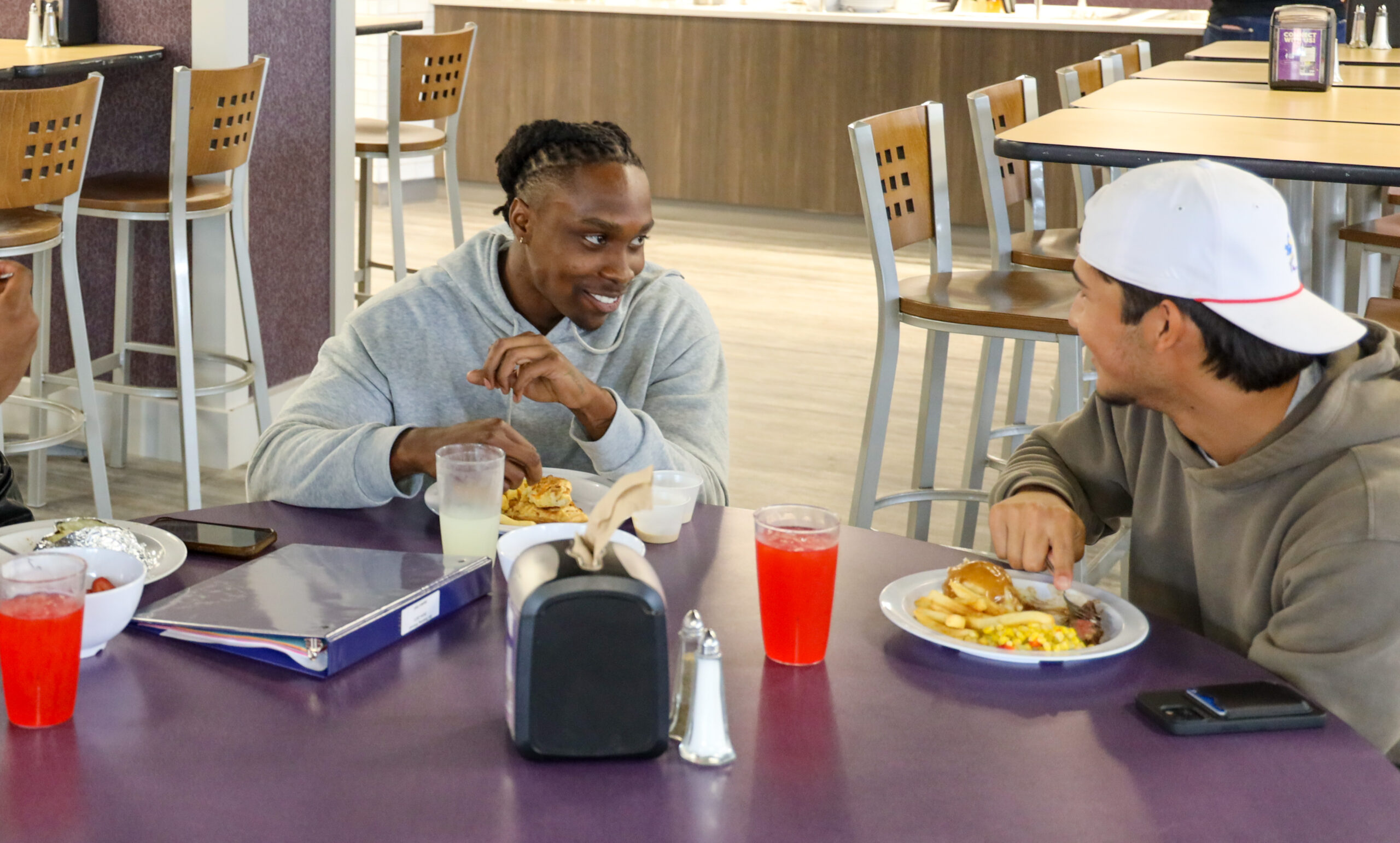 Two male students eating