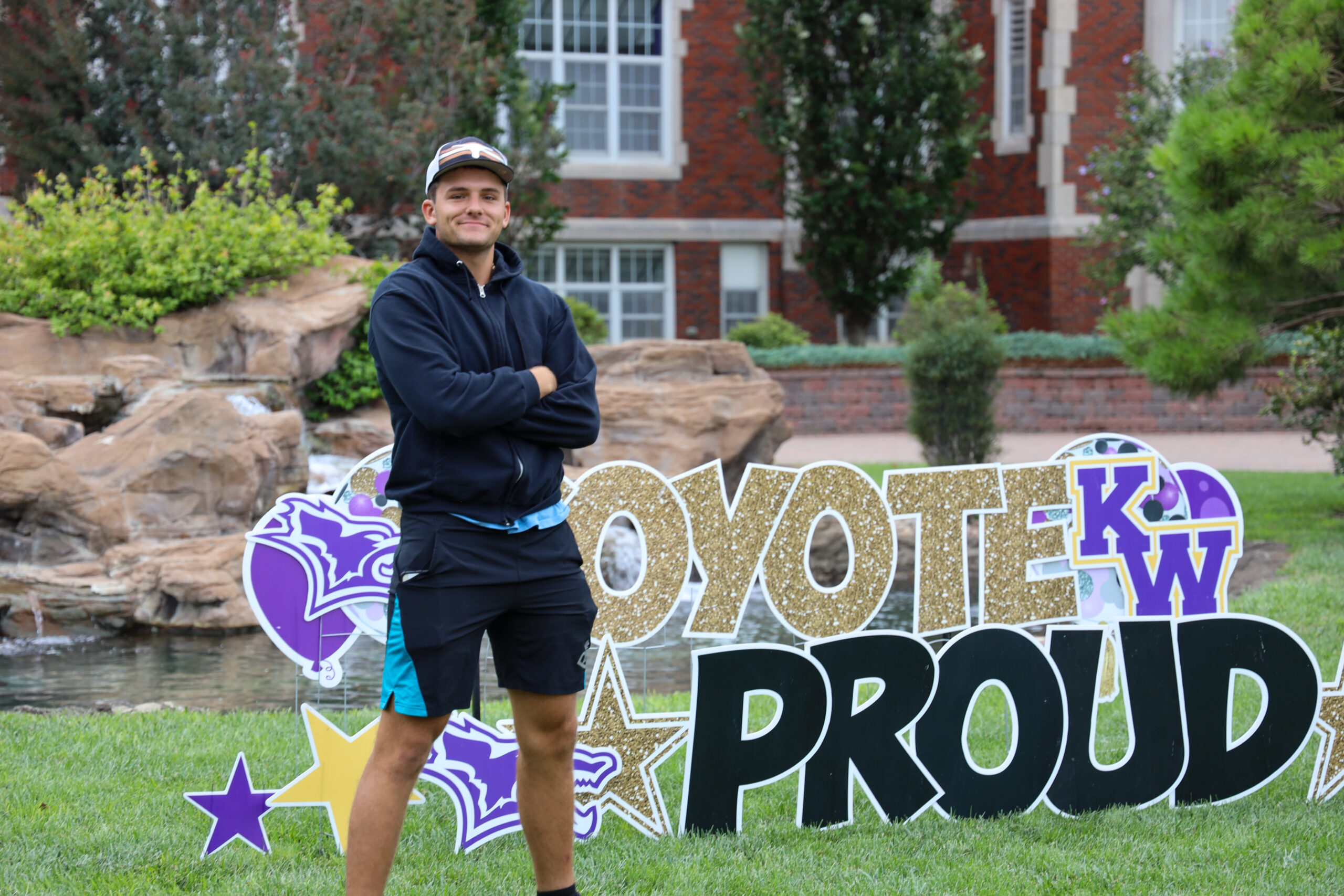 Male student in front of introduction sign