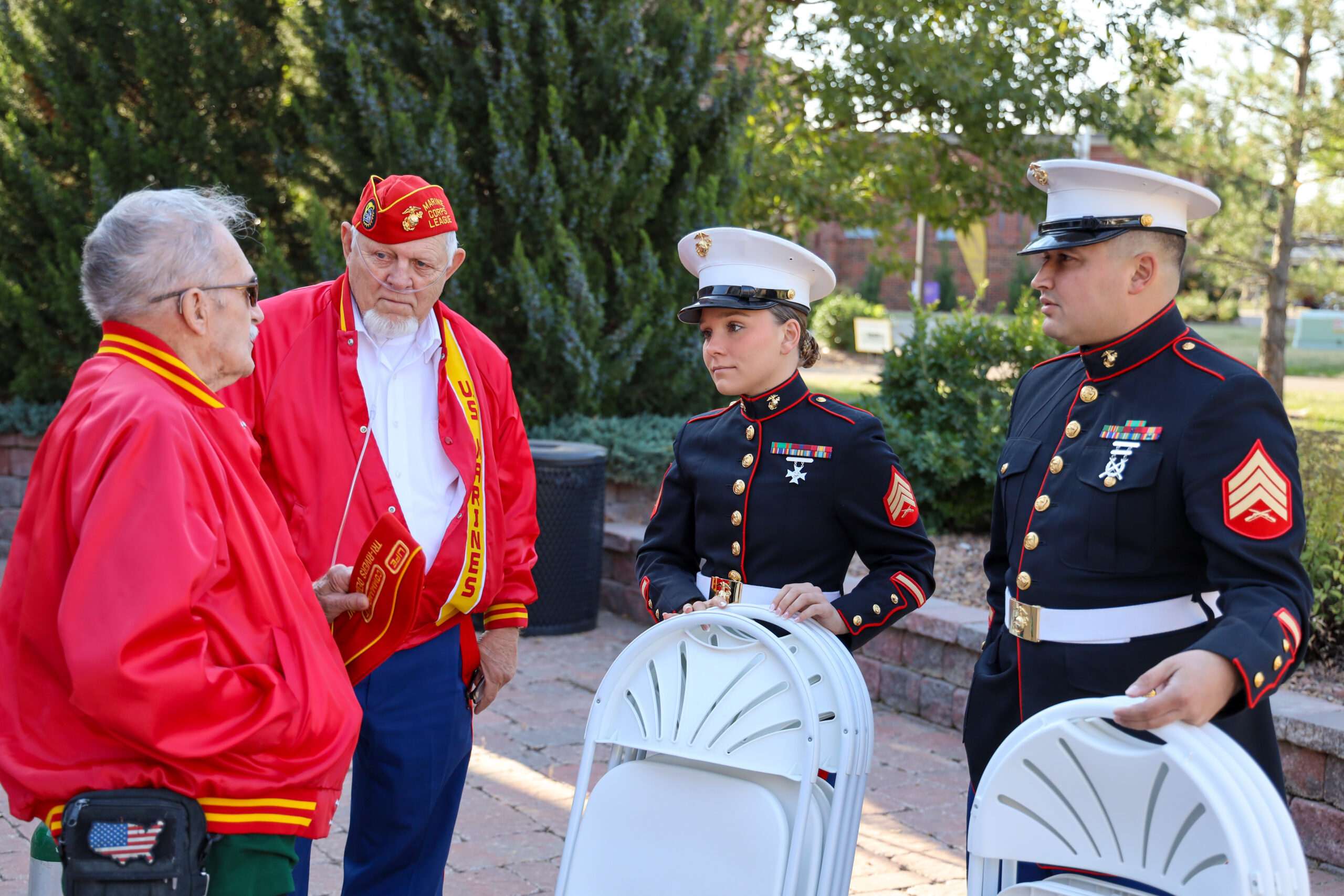 Individuals in uniform at Veterans Ceremony with speaker