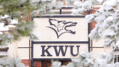 Snowy flower on campus in front of building