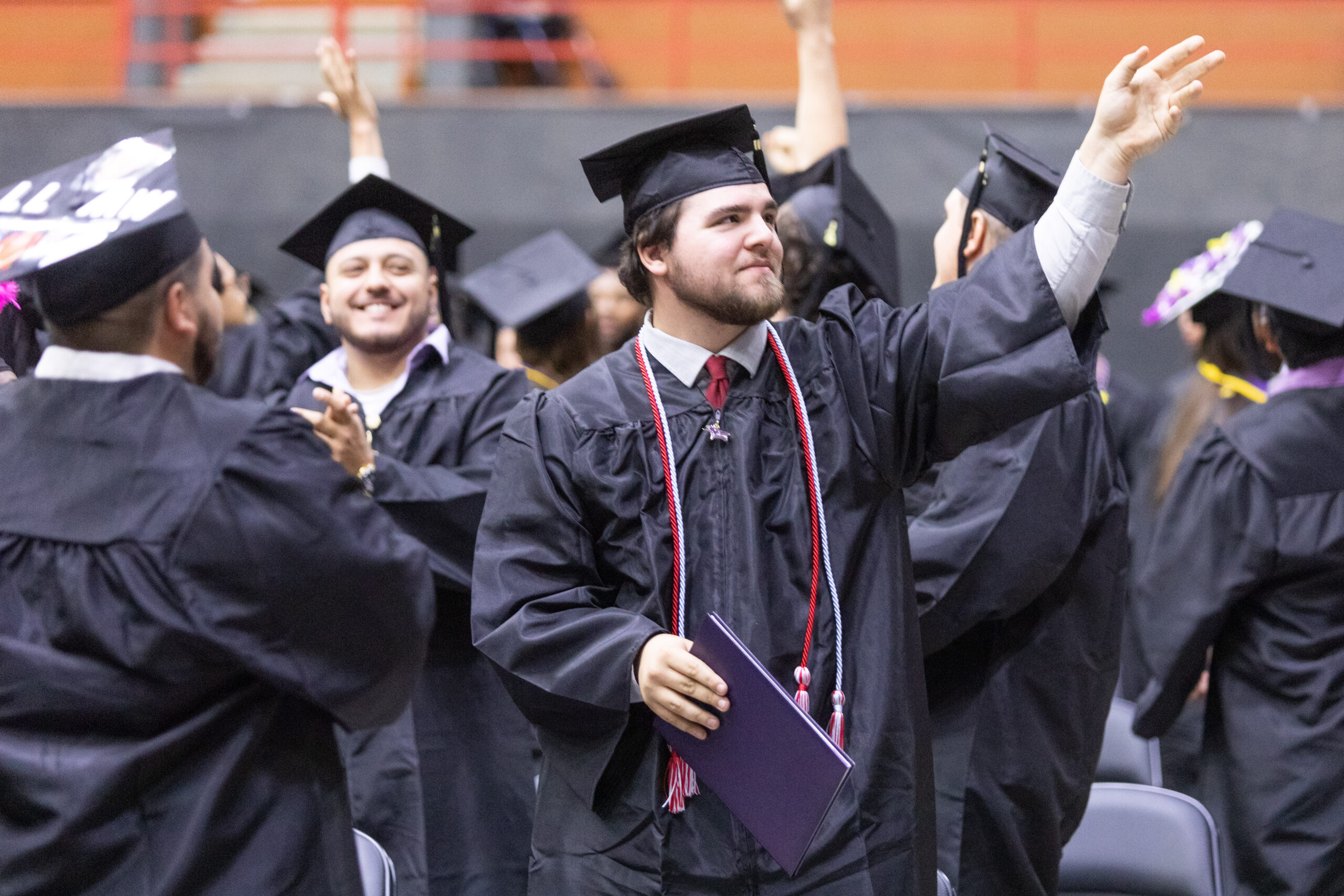 Graduate waving to crowd