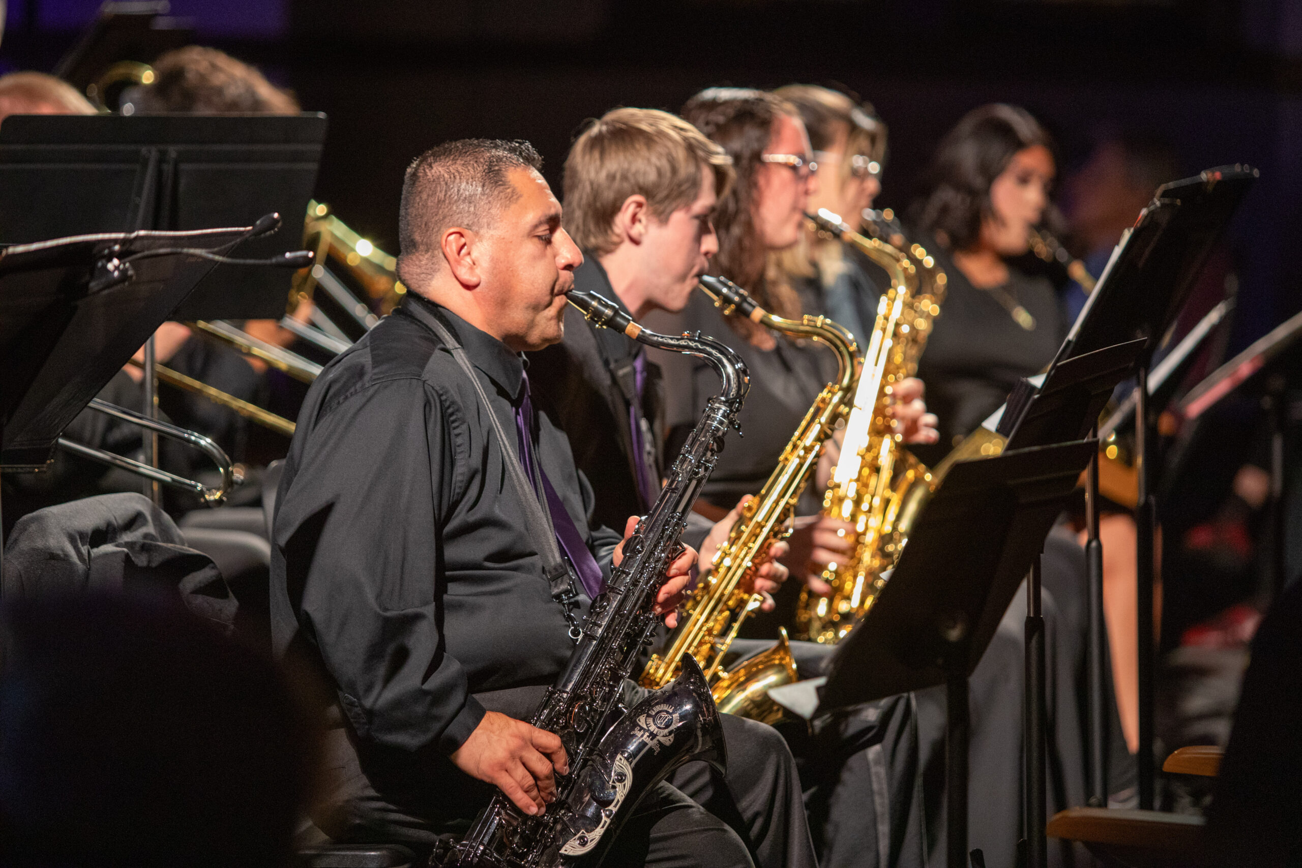 Individuals playing saxophone