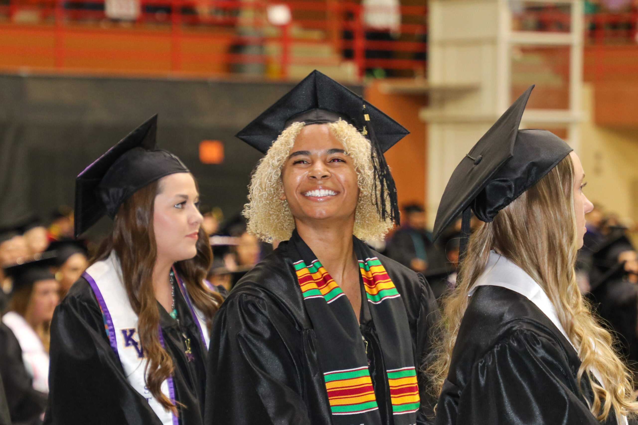 Woman in graduation attire smiling