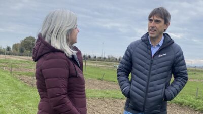 Man and woman standing next to each other on farmland