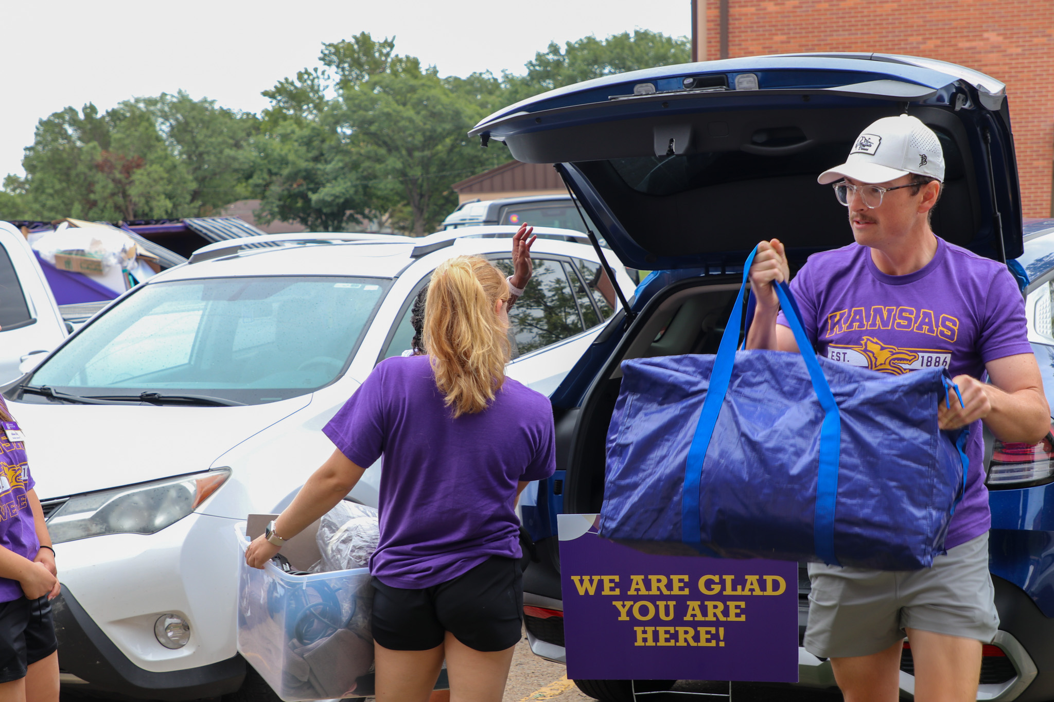 People moving items out of trunk