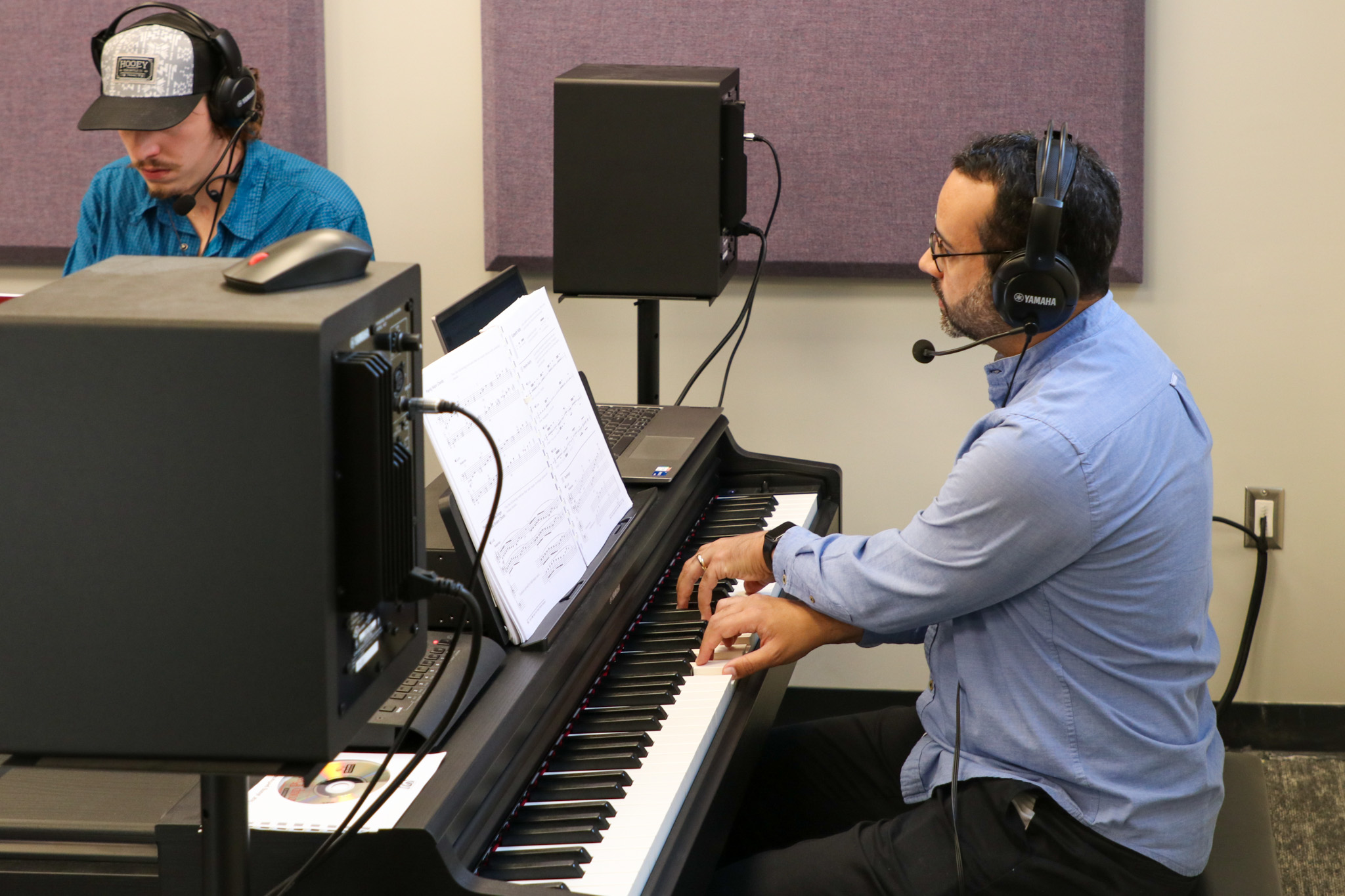 Instructor and student with pianos