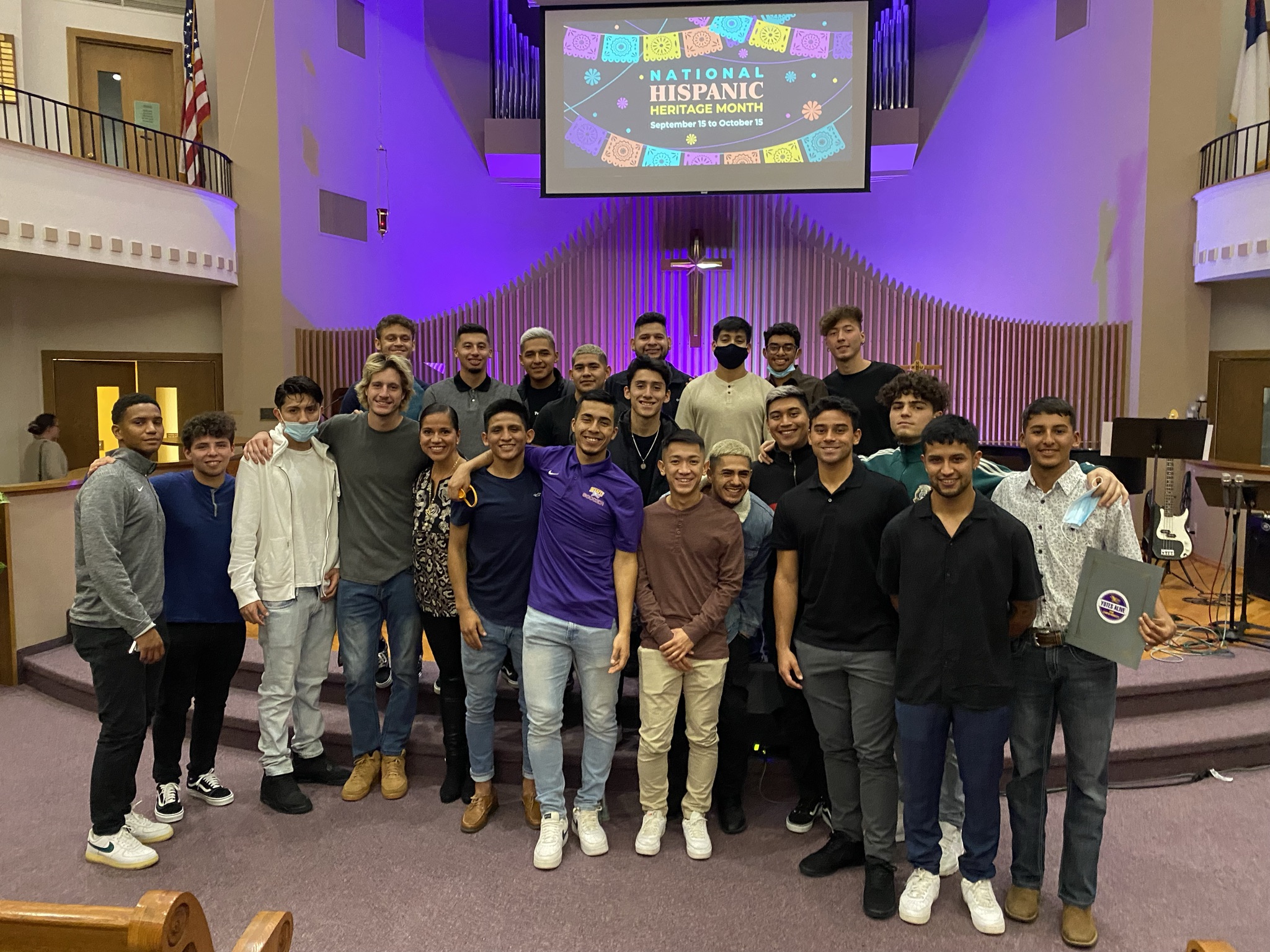 Group of people in front of church pulpit