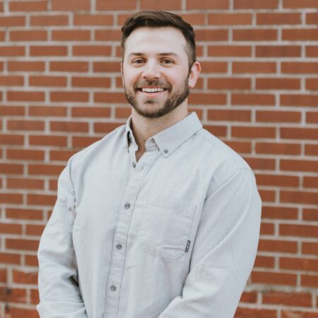 Photo of man in gray button-down shirt