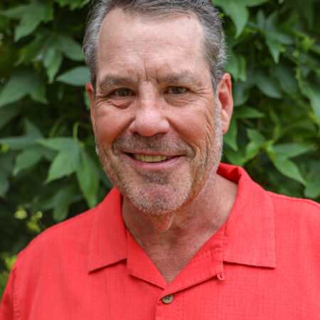 Head shot of man in salmon polo