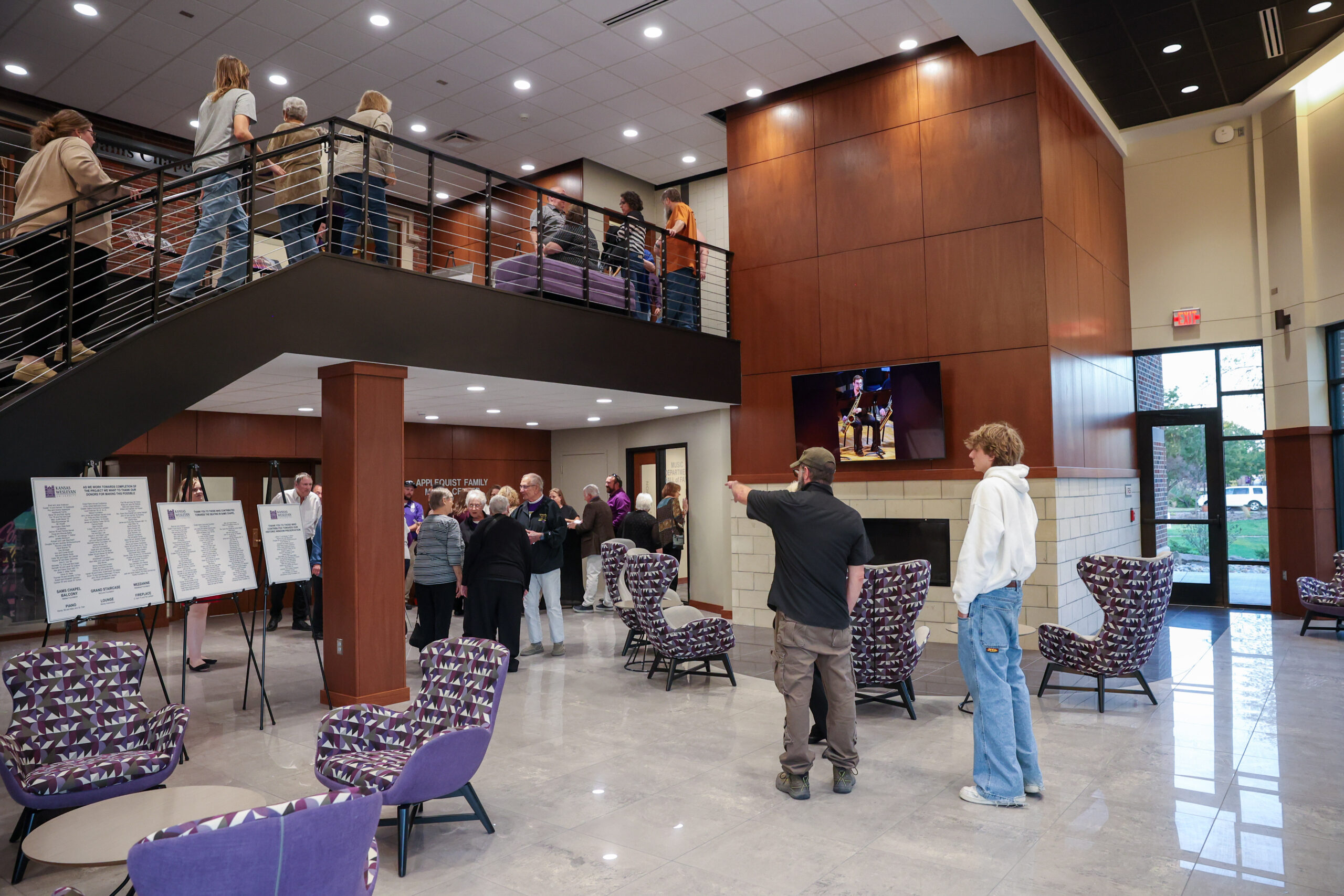 Wide angle shot inside Bieber Hall, people milling about